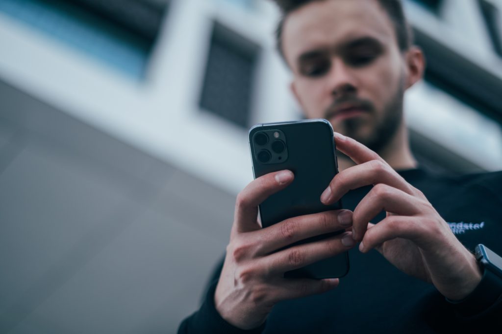 man looking at phone for reviews