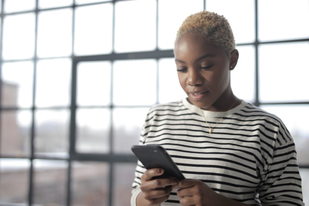 black woman looking at phone 