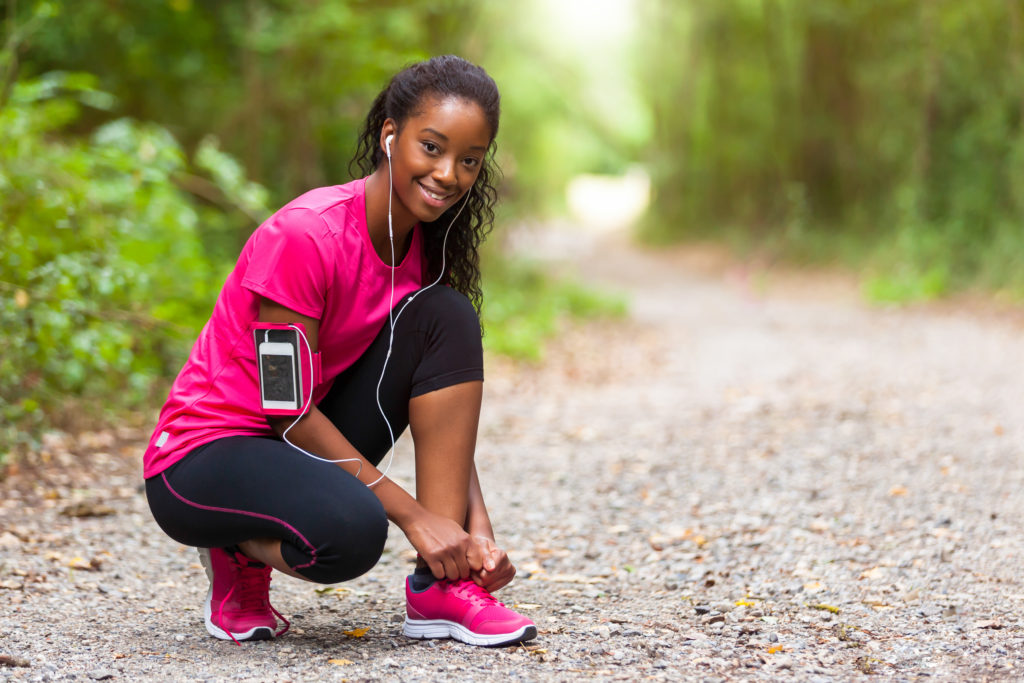 black girl tying shoes for a run 