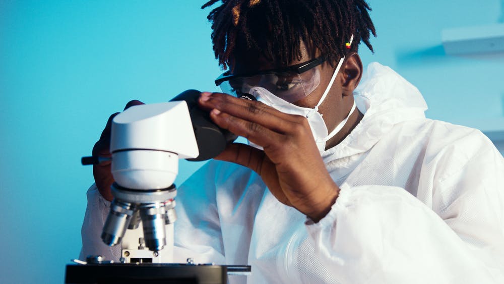 how to avoid burnout: scientist looking through microscope