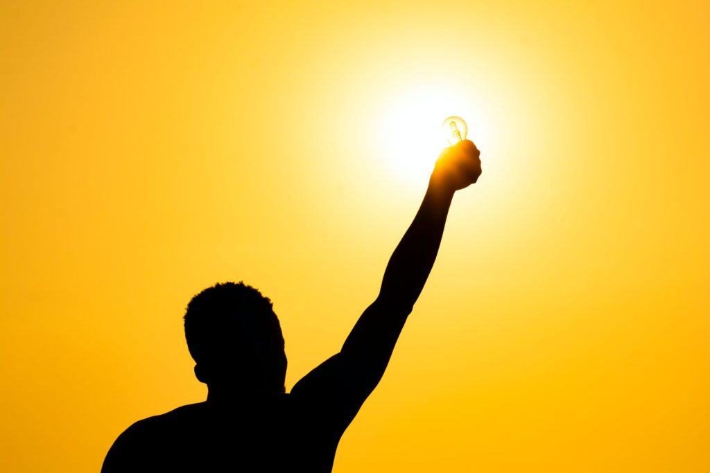 man reaching out hand to sky to avoid burnout