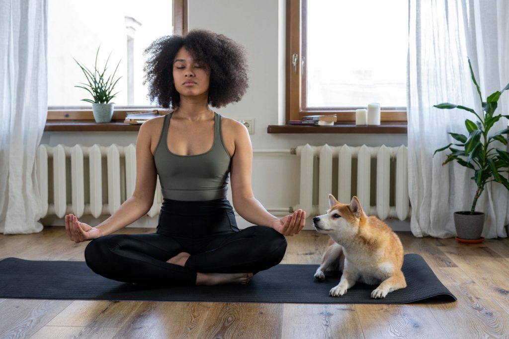 how to avoid burnout:girl meditating on yoga mat
