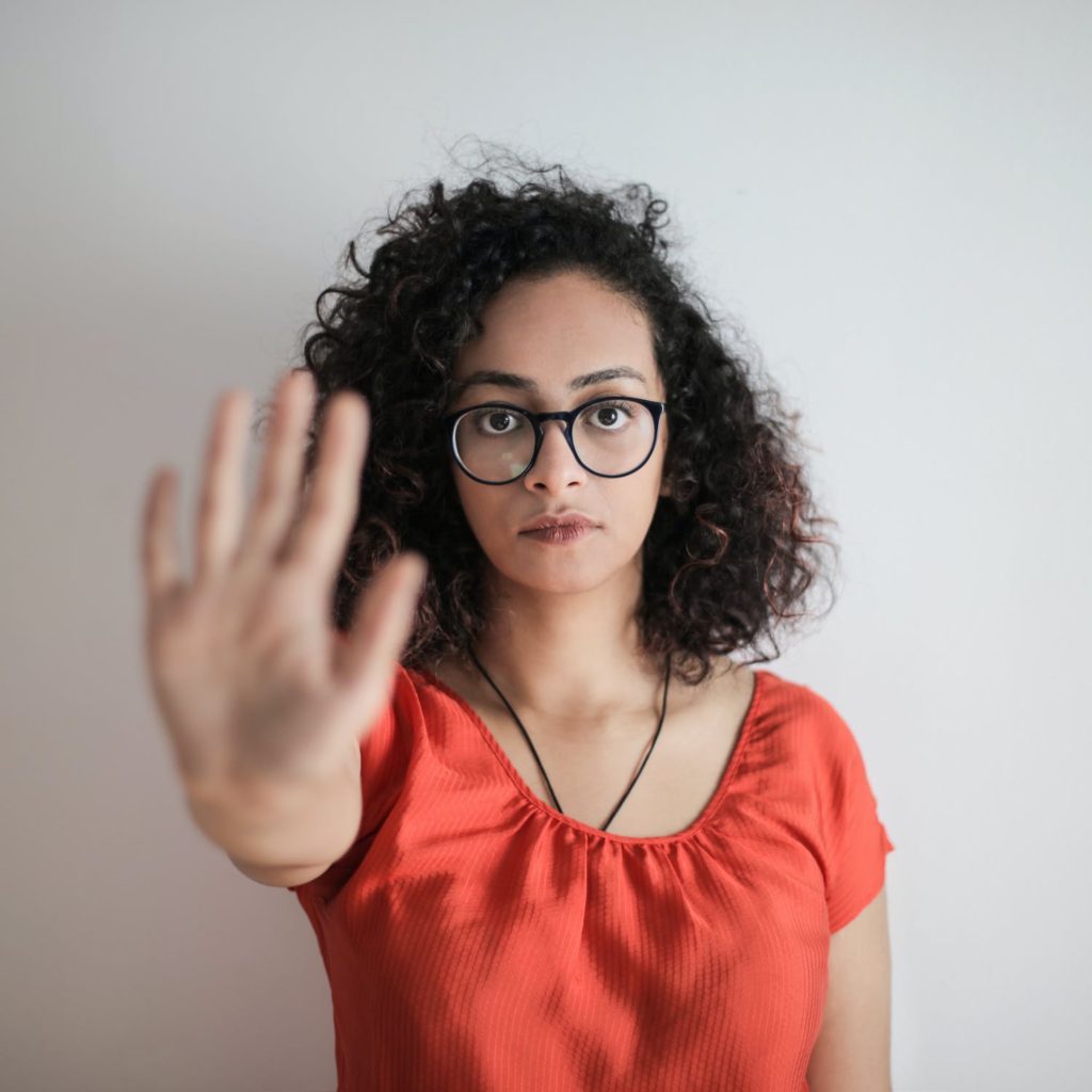 woman Standing out stretching hand out to stop