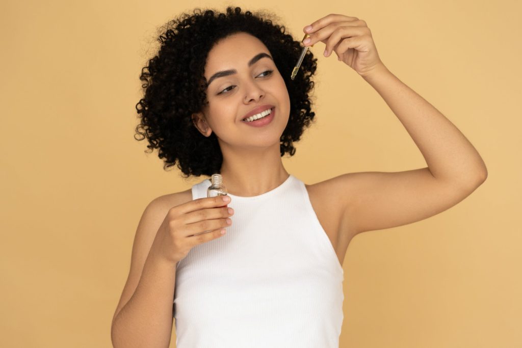 what's in my hair: girl holding hair ingredient bottle