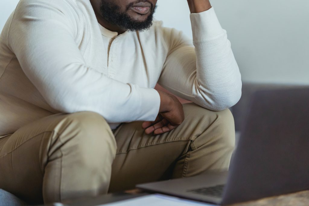 man at table with laptop