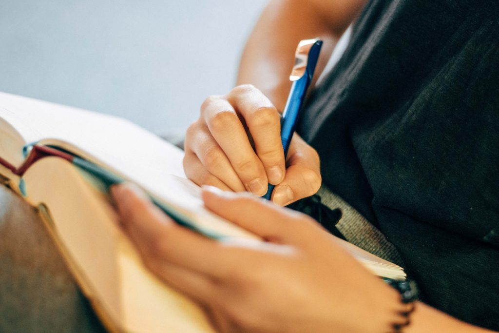 girl writing in book