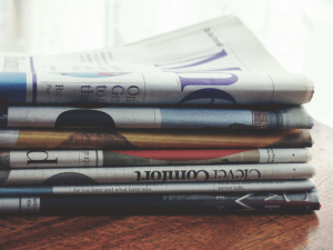 how to get press coverage: image with newspapers