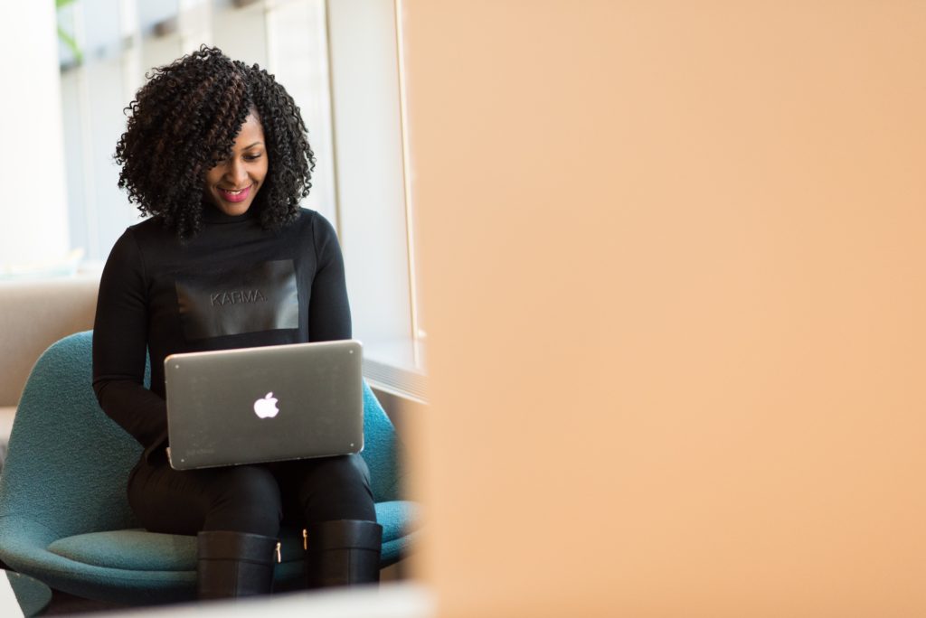 girl on laptop smiling - pexels pic